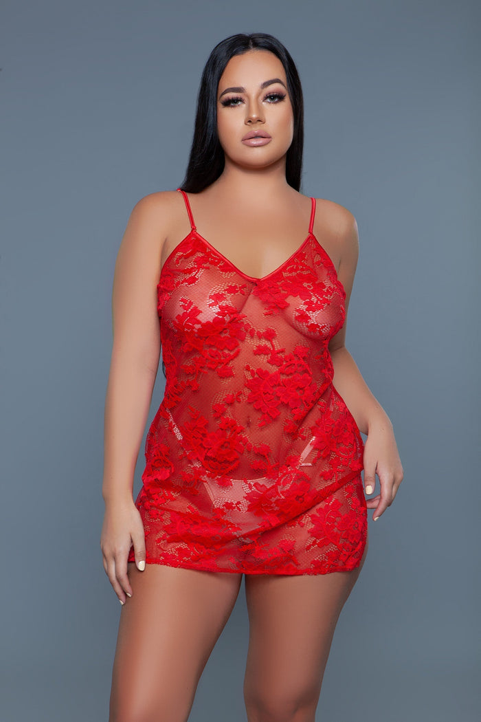 Woman wearing a red lace nightgown against a gray background