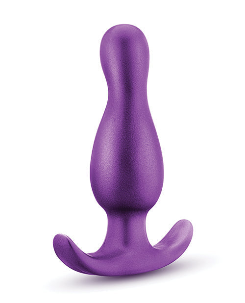 Purple silicone butt plug on a white background