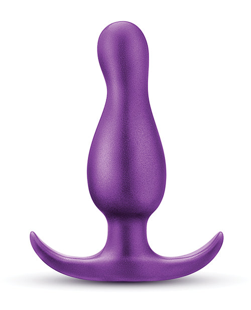 Purple silicone butt plug on a white background