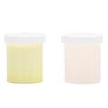 Two cylindrical containers with white lids on a white background