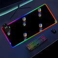 Wireless charging mousepad that is lit up around it with a colorful upside down pineapple on it, laying on a desk.
