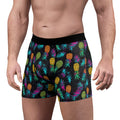 Colorful pineapple-patterned boxer briefs on a white background
