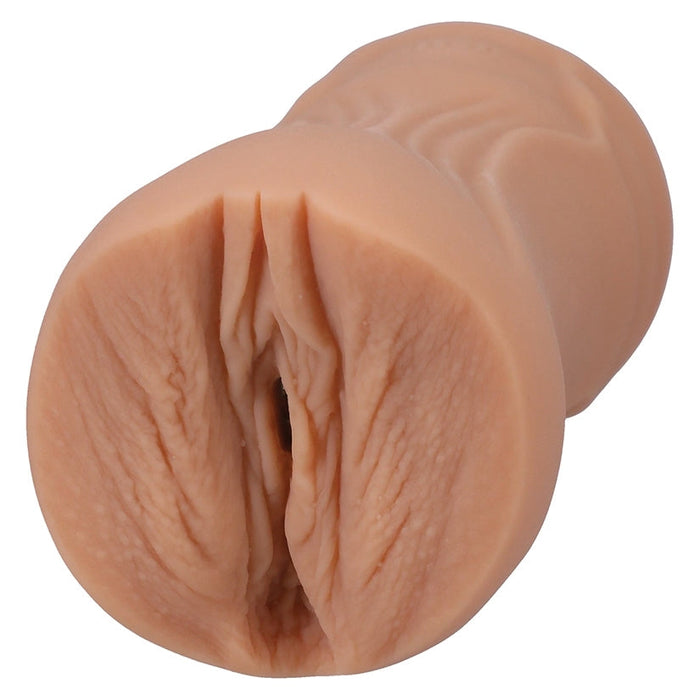 Realistic silicone model of a female reproductive organ on a white background